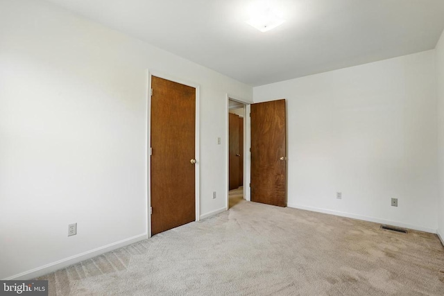 unfurnished bedroom featuring baseboards and carpet floors
