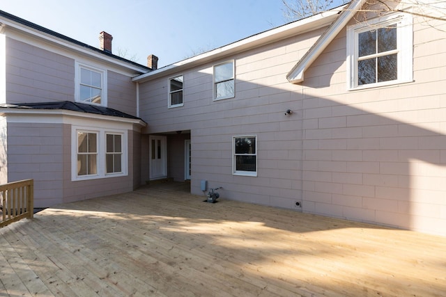 rear view of property featuring a wooden deck