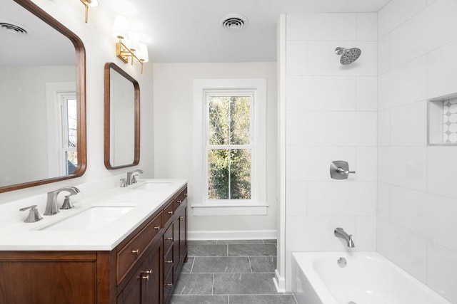 bathroom with vanity, tile patterned flooring, and tiled shower / bath combo