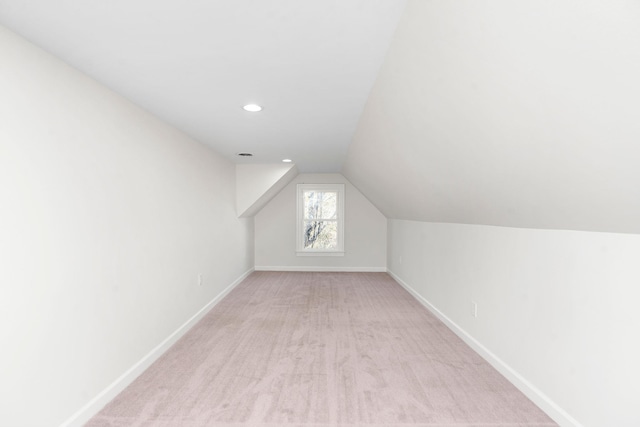 additional living space with lofted ceiling and light colored carpet