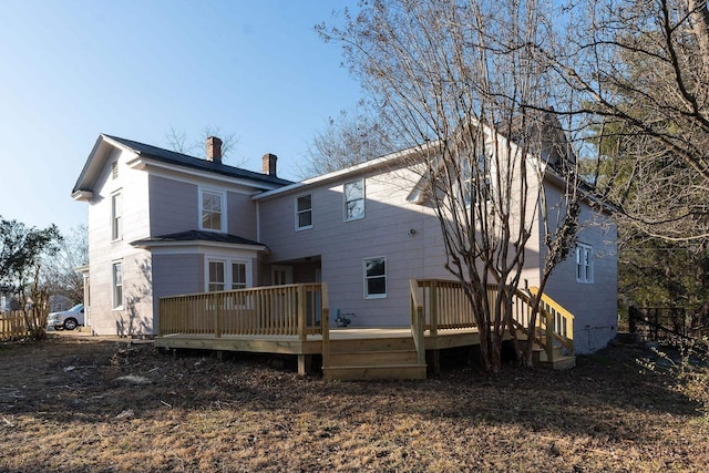 rear view of house featuring a deck