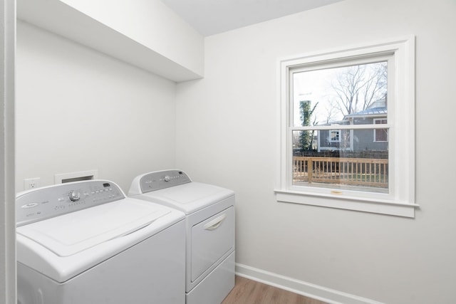 washroom featuring washing machine and clothes dryer and light wood-type flooring