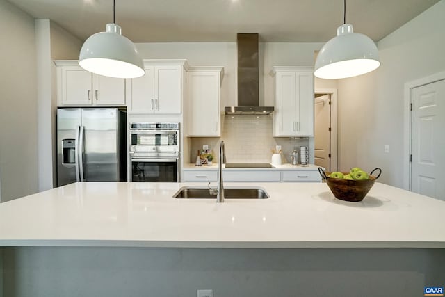 1658 Koch Ct, Charlottesville, VA 22911 - kitchen featuring a sink, wall chimney exhaust hood, backsplash, a kitchen island with sink, and appliances with stainless steel finishes