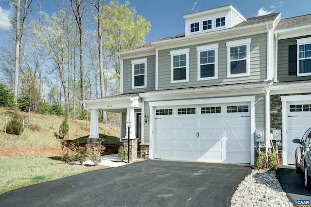 1658 Koch Ct, Charlottesville, VA 22911 - view of side of home featuring an attached garage, stone siding, and driveway