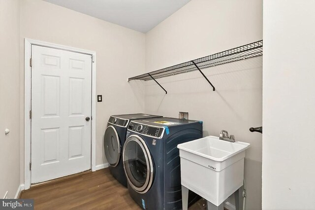 - washroom featuring washer and clothes dryer and dark wood-type flooring