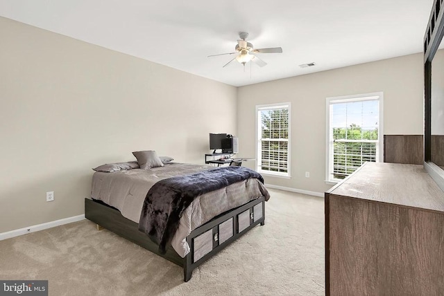  - bedroom with light colored carpet and a ceiling fan