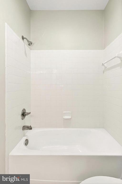  - bathroom with bathing tub / shower combination and toilet