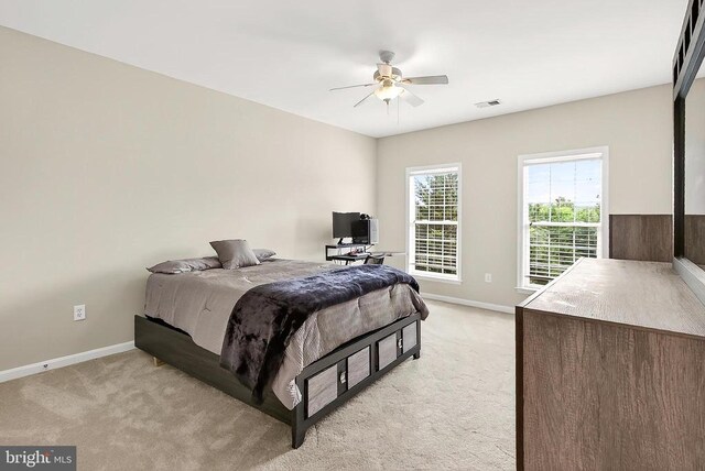 - bedroom with light colored carpet and a ceiling fan