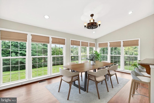  - sunroom / solarium with healthy amount of natural light, a chandelier, vaulted ceiling, wood finished floors, and recessed lighting