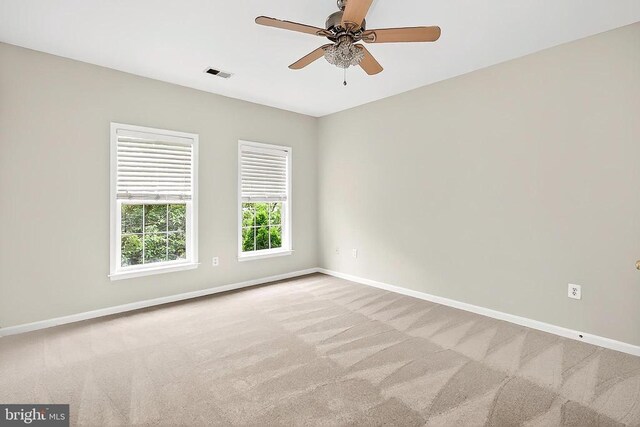  - carpeted empty room featuring baseboards and ceiling fan