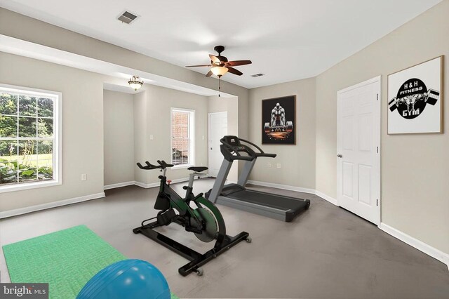  - living room featuring light colored carpet, ceiling fan, and a multi sided fireplace