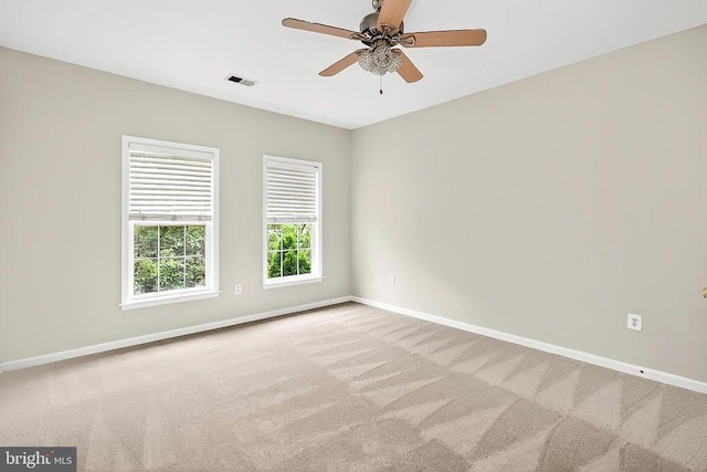  - carpeted empty room featuring baseboards and ceiling fan