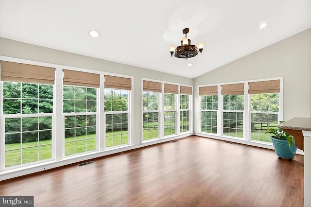  - unfurnished sunroom with lofted ceiling, a chandelier, healthy amount of natural light, recessed lighting, and wood finished floors