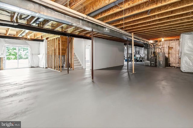  - below grade area with gas water heater, stairway, and heating unit