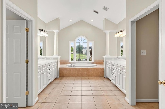  - full bathroom with two vanities, ornate columns, tile patterned flooring, lofted ceiling, and a bath