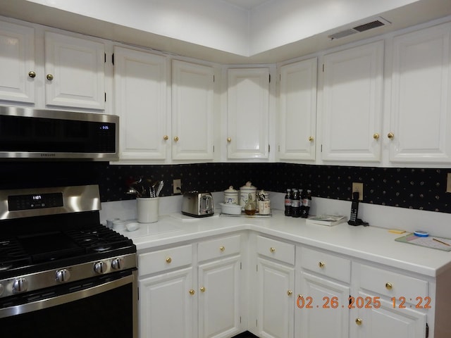 49 Edgewood Ct, Hot Springs, VA 24445 - kitchen featuring stainless steel appliances, light countertops, visible vents, and white cabinets