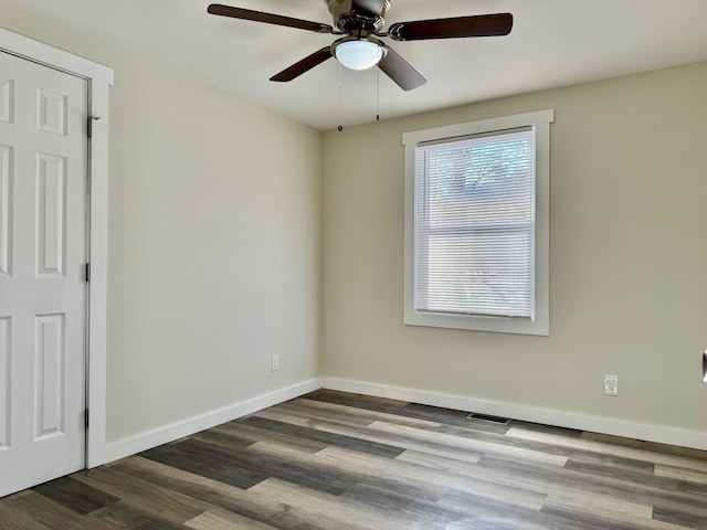 spare room with hardwood / wood-style floors and ceiling fan