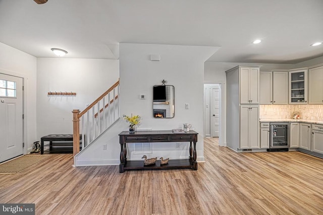 295 Hemlock Loop, Mineral, VA 23117 - foyer with wine cooler, light wood-type flooring, baseboards, stairway, and recessed lighting