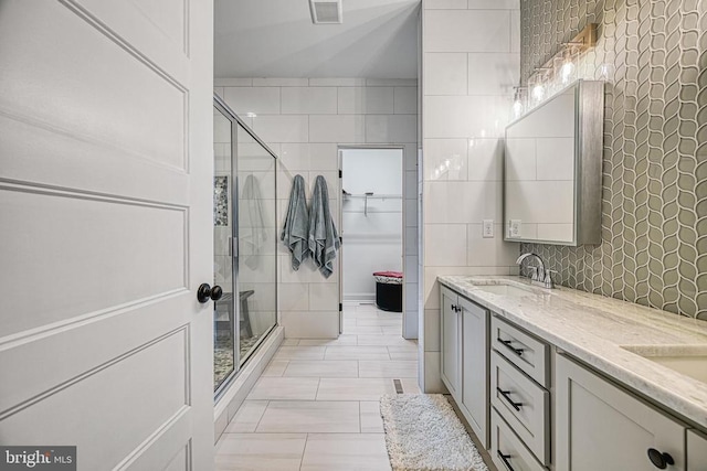 295 Hemlock Loop, Mineral, VA 23117 - full bath featuring a shower stall, double vanity, tile walls, and a spacious closet