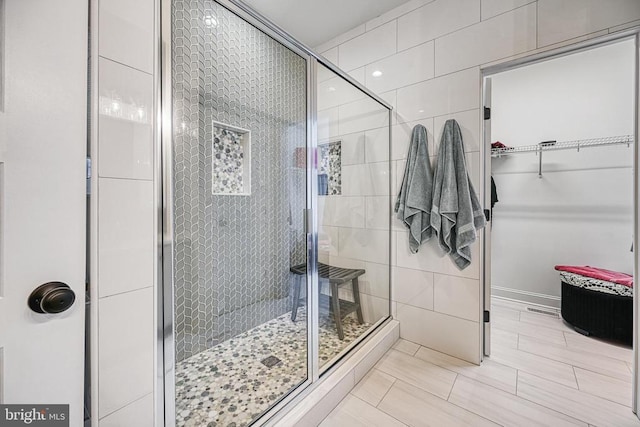 295 Hemlock Loop, Mineral, VA 23117 - full bath featuring a shower stall, tile walls, a walk in closet, baseboards, and tile patterned floors