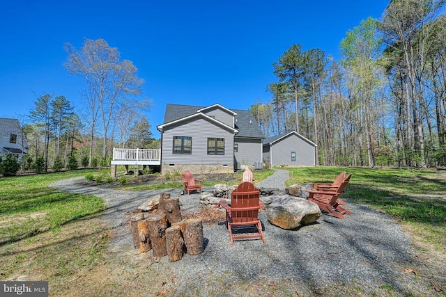 295 Hemlock Loop, Mineral, VA 23117 - rear view of property with an outdoor fire pit, a wooden deck, a lawn, and crawl space