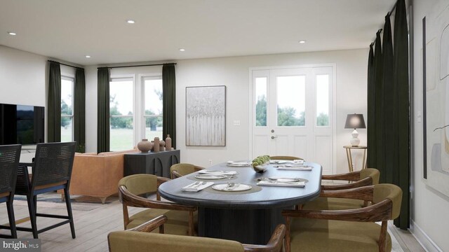  - dining area featuring healthy amount of natural light, light wood-style flooring, and recessed lighting