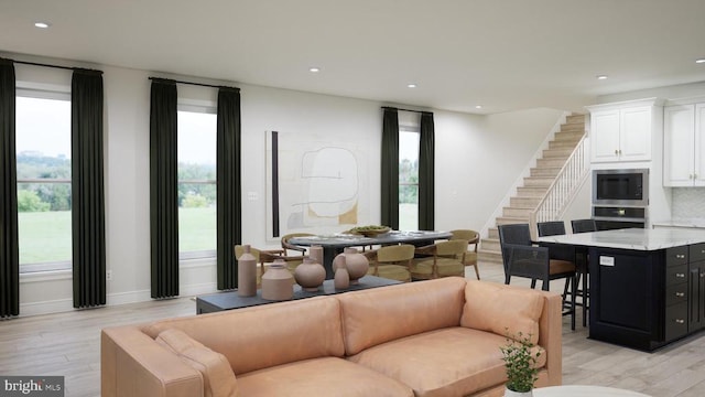  - living room featuring light wood-style flooring, stairway, and recessed lighting
