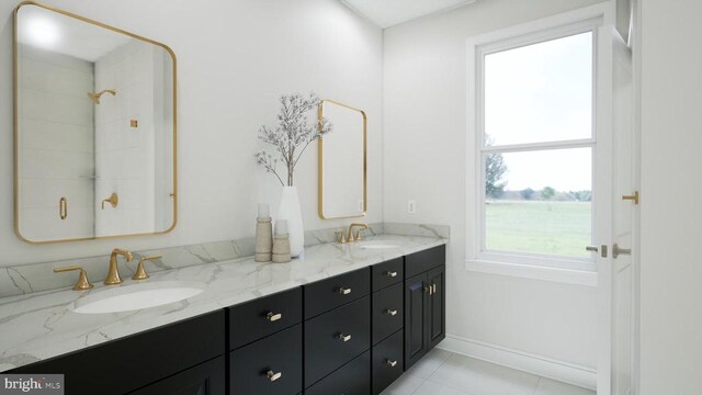  - full bath with double vanity, healthy amount of natural light, and tile patterned floors