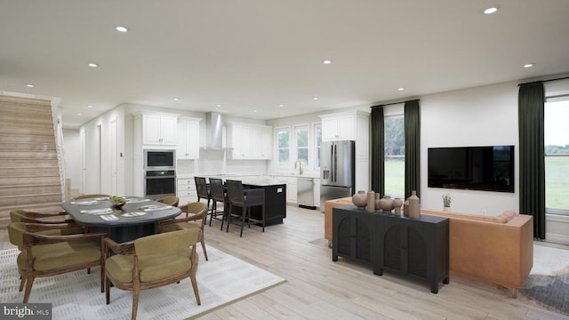  - dining room with recessed lighting, light wood-style flooring, and stairs