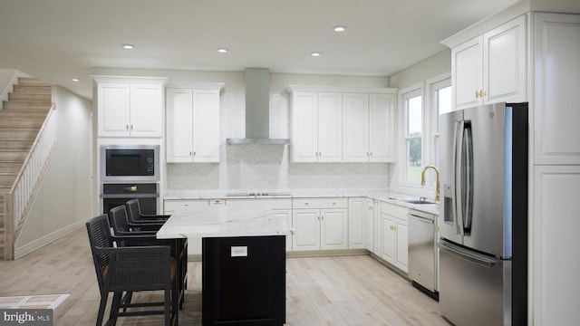  - kitchen with black appliances, tasteful backsplash, white cabinets, wall chimney exhaust hood, and recessed lighting