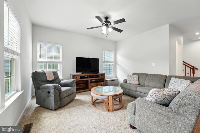  - carpeted living room with healthy amount of natural light and a ceiling fan