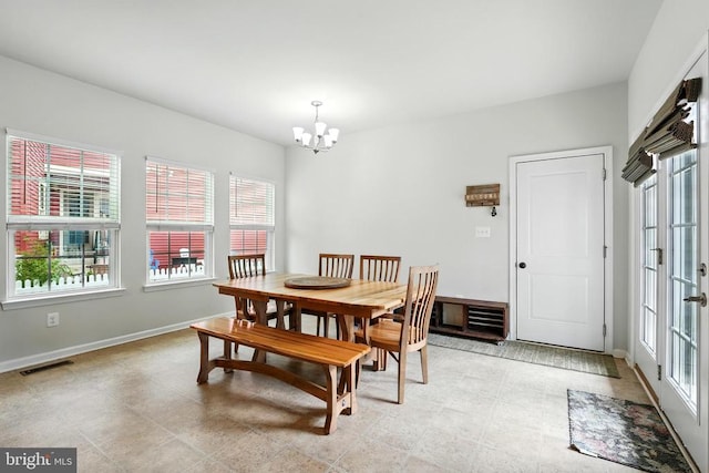 - dining area with a chandelier and healthy amount of natural light