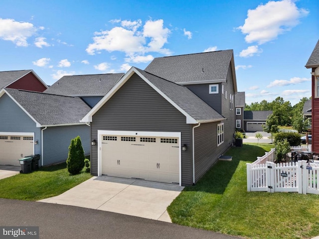  - traditional-style home with an attached garage, driveway, roof with shingles, and a gate