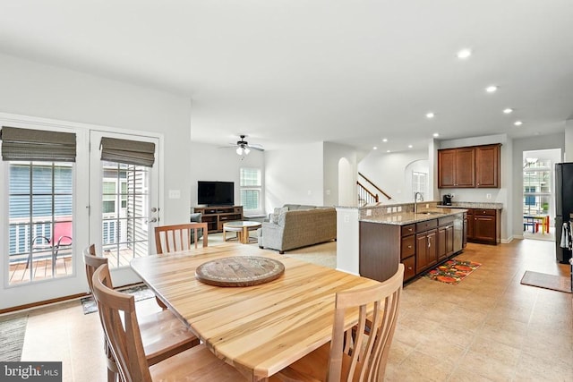  - dining room featuring a ceiling fan, healthy amount of natural light, recessed lighting, stairway, and arched walkways