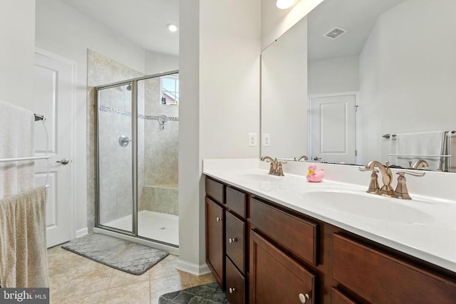  - full bath with tile patterned flooring, a stall shower, and double vanity