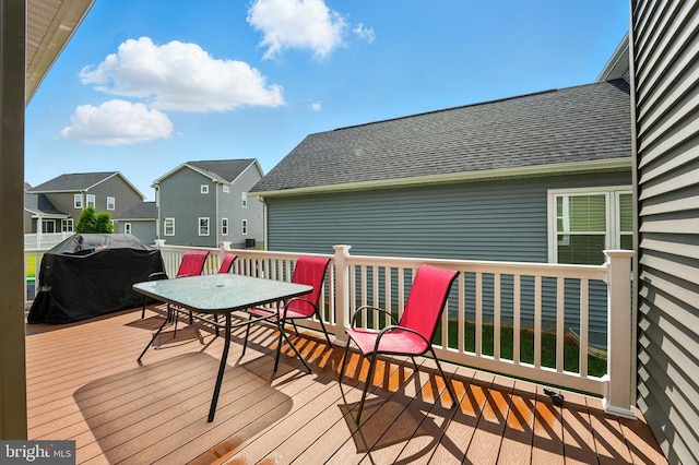  - deck featuring outdoor dining space, a residential view, and a grill