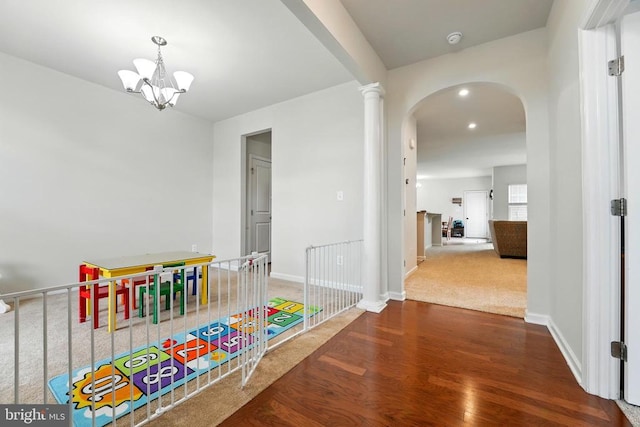  - recreation room featuring wood finished floors, arched walkways, a chandelier, and recessed lighting