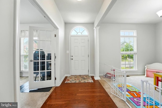  - foyer with plenty of natural light, wood finished floors, and ornate columns