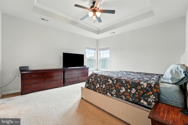  - bedroom with a tray ceiling, ornamental molding, carpet floors, and a ceiling fan