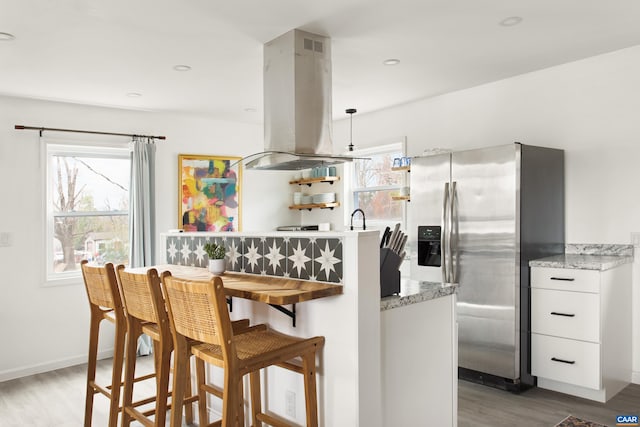 1795 Avon Rd, Afton, VA 22920 - kitchen with stainless steel refrigerator with ice dispenser, island exhaust hood, white cabinetry, wood finished floors, and open shelves