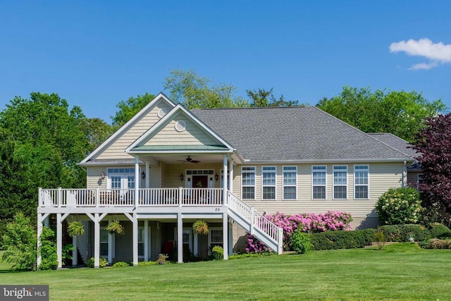 rear view of house featuring a yard, a wooden deck, ceiling fan, and stairs
