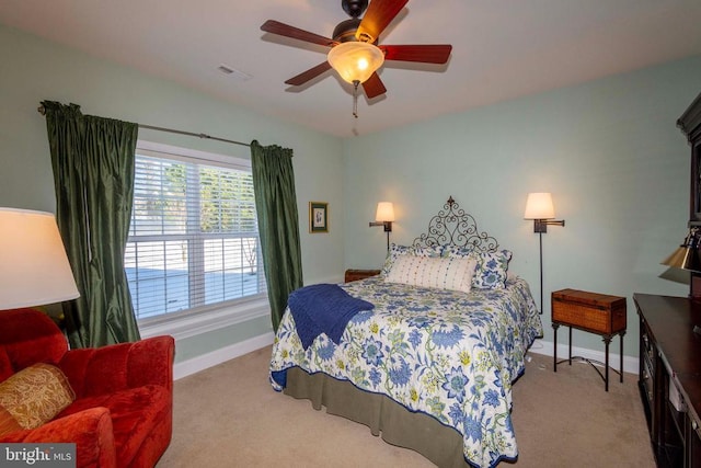 carpeted bedroom featuring baseboards, visible vents, and ceiling fan