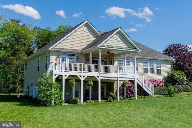 back of house with a lawn, a deck, stairway, and ceiling fan