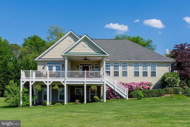 back of house featuring a deck, a lawn, ceiling fan, and stairs
