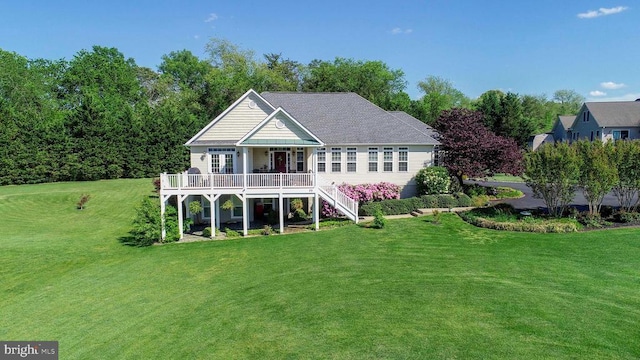 back of property with a yard, stairs, and a wooden deck