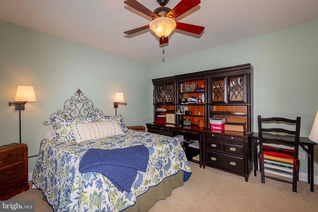 carpeted bedroom with baseboards and ceiling fan