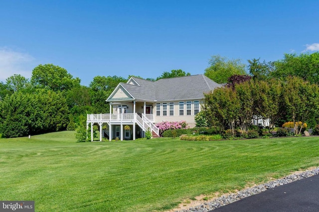 view of front of property with a front yard and stairs