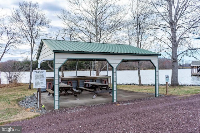exterior space with a water view and a carport