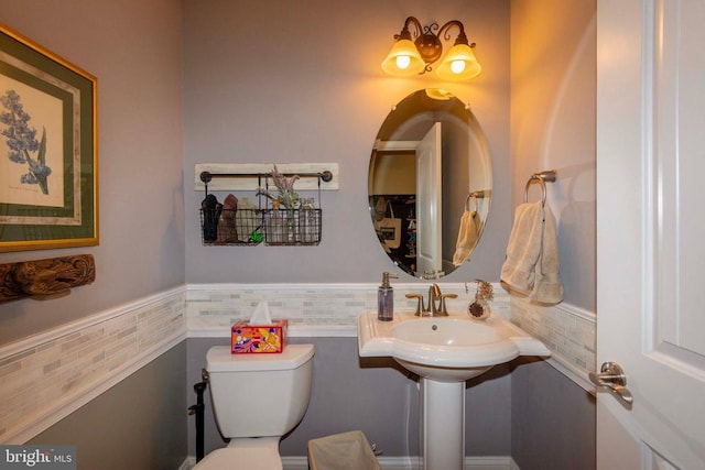 bathroom featuring toilet and wainscoting