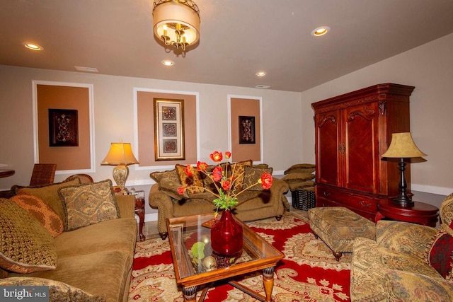 living room featuring baseboards, visible vents, and recessed lighting